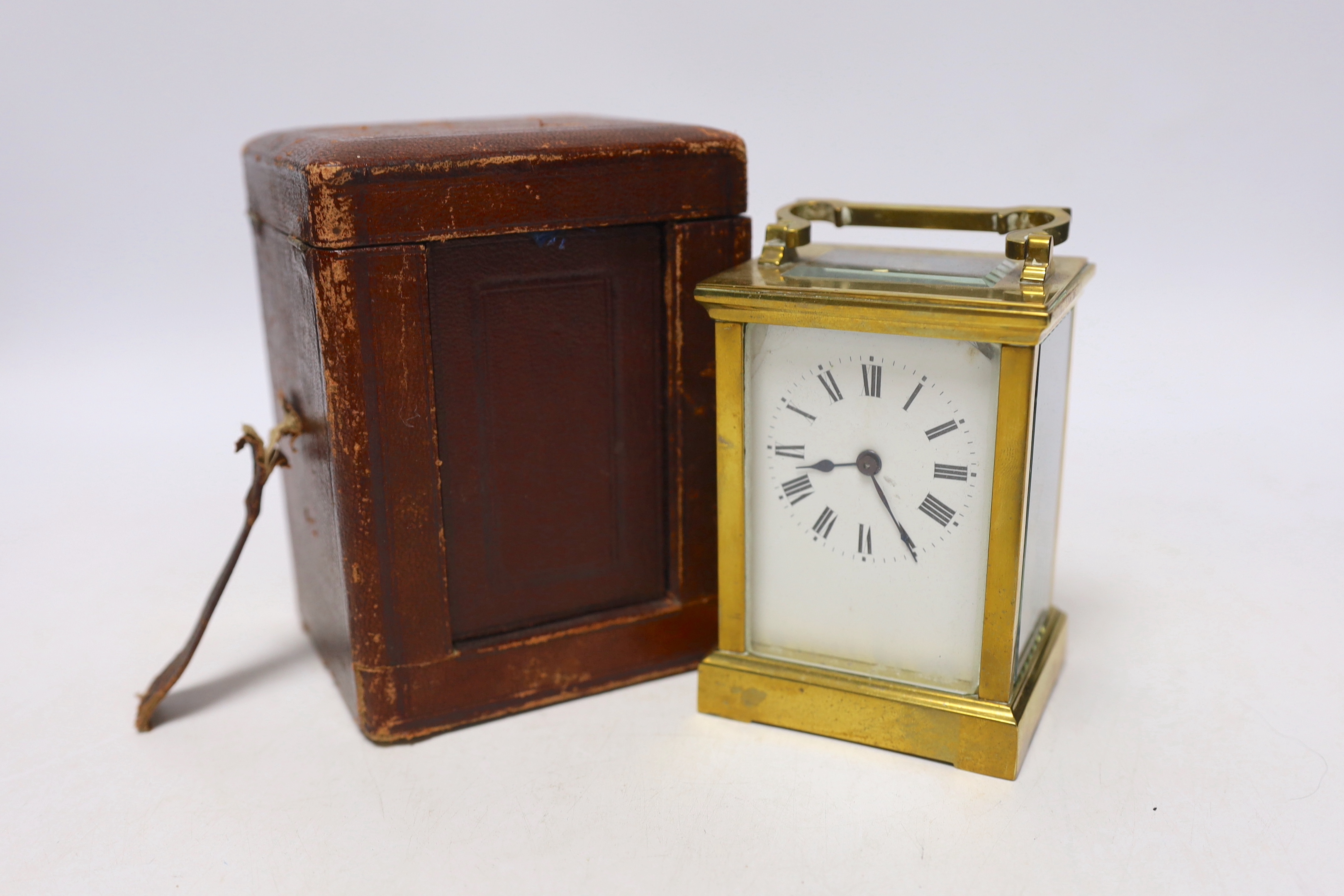 A cased brass carriage timepiece, 14cm high